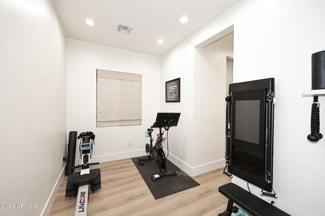 exercise room featuring light hardwood / wood-style flooring