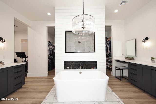 bathroom with wood-type flooring, vanity, and separate shower and tub