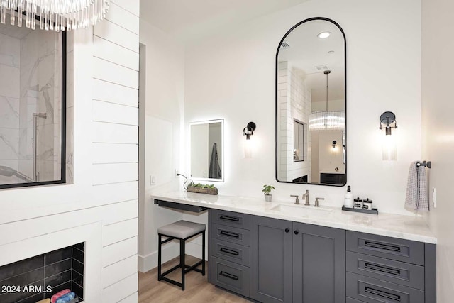 bathroom featuring an inviting chandelier, vanity, and hardwood / wood-style floors