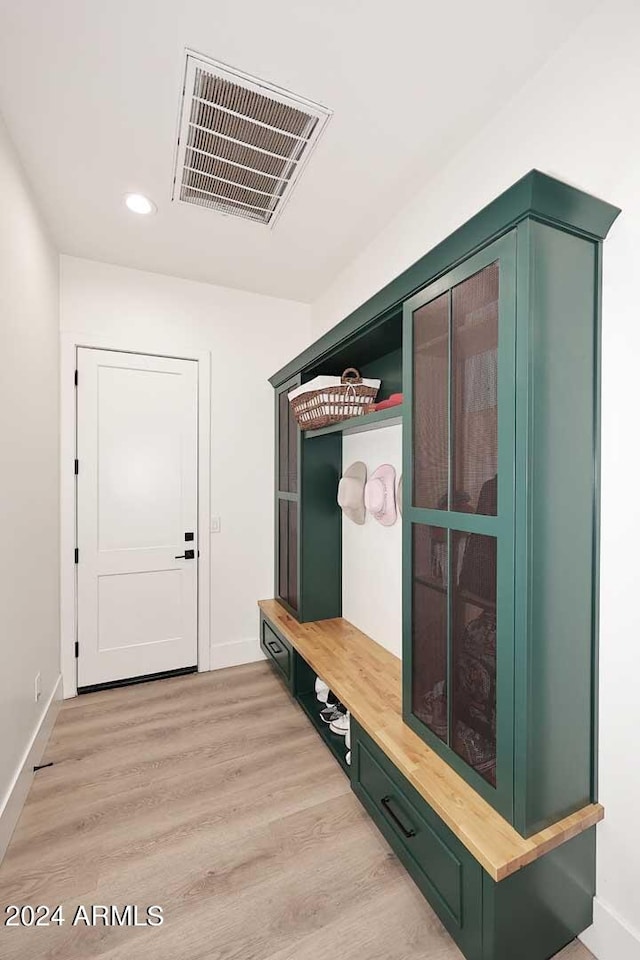 mudroom with light hardwood / wood-style floors