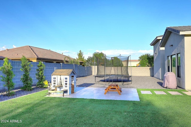 view of yard with a patio and a trampoline