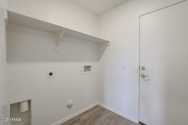 clothes washing area with electric dryer hookup, washer hookup, wood finished floors, baseboards, and laundry area