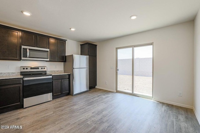 kitchen with baseboards, recessed lighting, dark brown cabinetry, appliances with stainless steel finishes, and light wood-type flooring