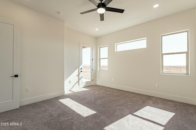 unfurnished bedroom with ceiling fan, carpet floors, and multiple windows