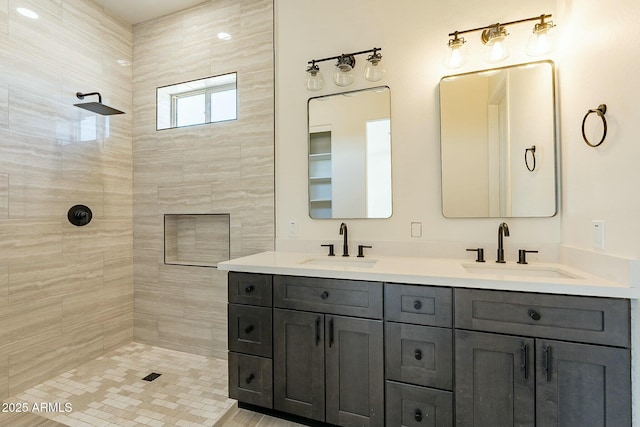 bathroom with vanity and a tile shower