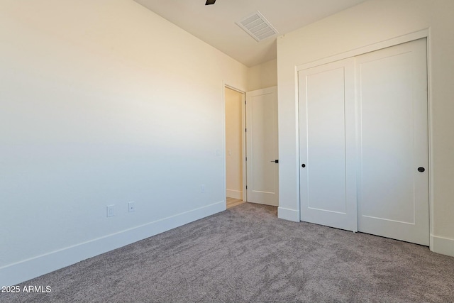 unfurnished bedroom featuring carpet flooring and a closet