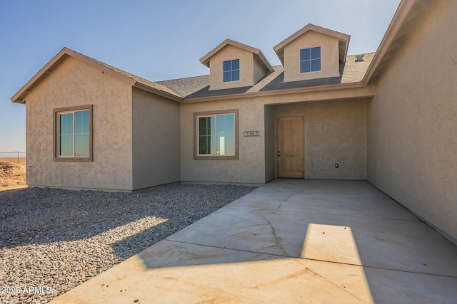 entrance to property featuring a patio