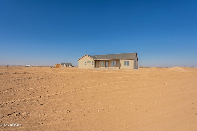 view of front facade with a rural view