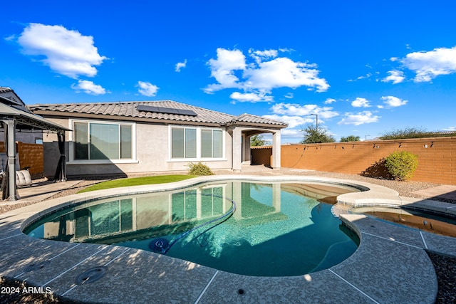 view of swimming pool featuring an in ground hot tub and a patio