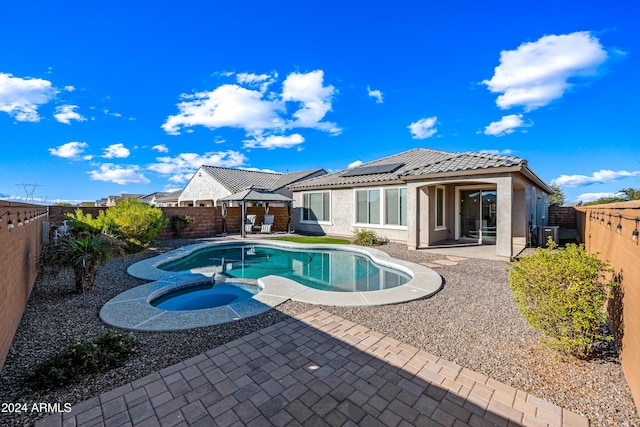 view of pool with an in ground hot tub and a patio area