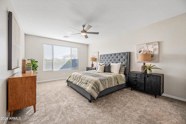 bedroom featuring light colored carpet and ceiling fan