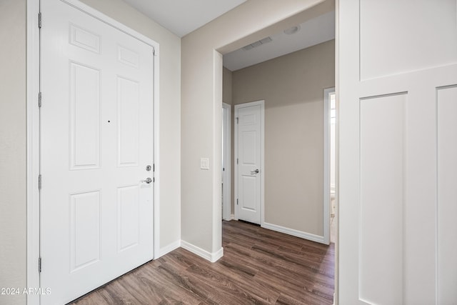 hallway with dark wood-type flooring