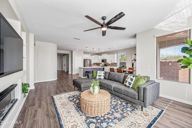 living room with hardwood / wood-style flooring and ceiling fan