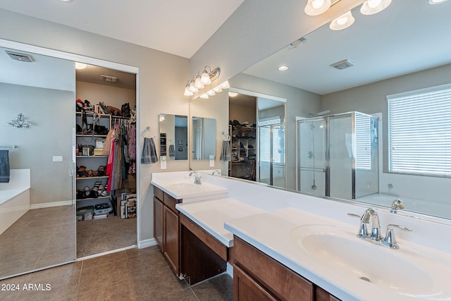 bathroom featuring tile patterned flooring, vanity, a healthy amount of sunlight, and independent shower and bath