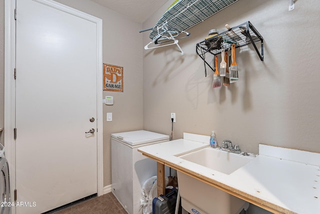 clothes washing area featuring sink