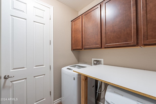 laundry area featuring cabinets, a textured ceiling, and hookup for a washing machine