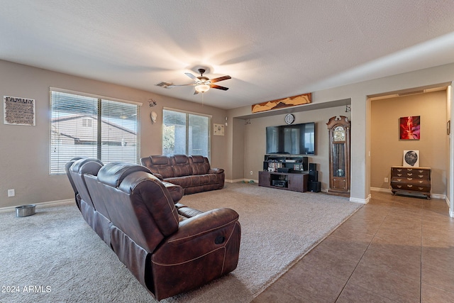 tiled living room featuring ceiling fan and a textured ceiling