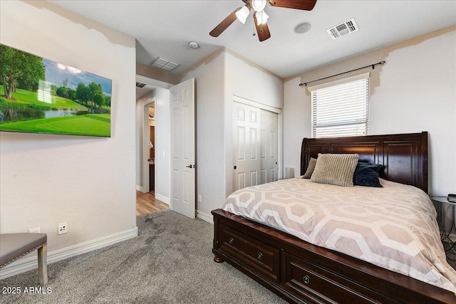 bedroom with a closet, carpet flooring, visible vents, and baseboards