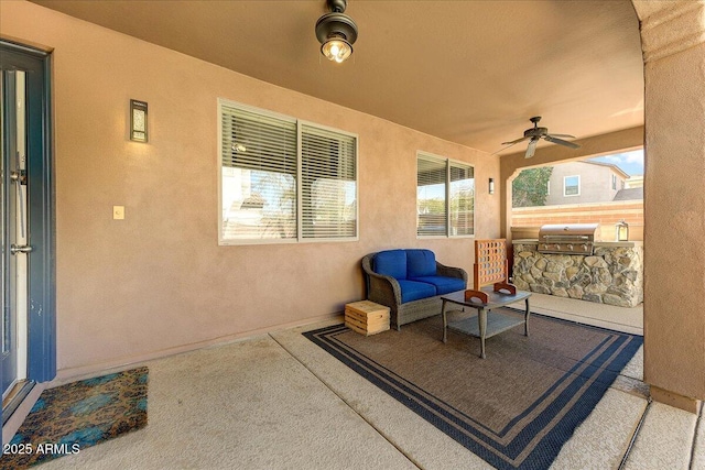 view of patio with area for grilling and a ceiling fan