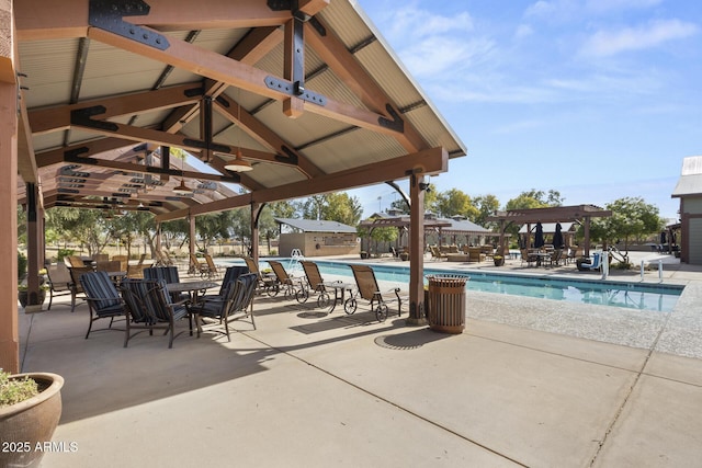 community pool featuring ceiling fan, a patio, a gazebo, and a pergola