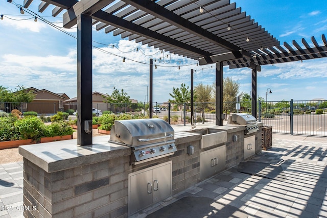 view of patio with area for grilling, fence, and a pergola