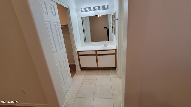 6784 W Gardenia Ave, Glendale, AZ 85303 - corridor with light tile patterned flooring, baseboards, and a sink