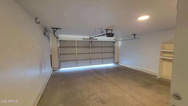 6784 W Gardenia Ave, Glendale, AZ 85303 - garage with baseboards and a garage door opener