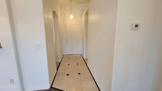 6784 W Gardenia Ave, Glendale, AZ 85303 - corridor featuring arched walkways and light tile patterned floors