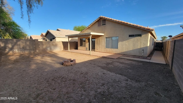 6784 W Gardenia Ave, Glendale, AZ 85303 - rear view of property featuring a tiled roof, a fenced backyard, a patio area, and stucco siding