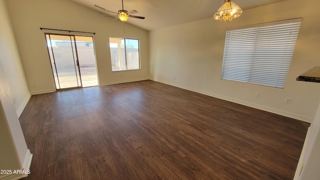 6784 W Gardenia Ave, Glendale, AZ 85303 - empty room with dark wood-style flooring, ceiling fan with notable chandelier, baseboards, lofted ceiling, and visible vents