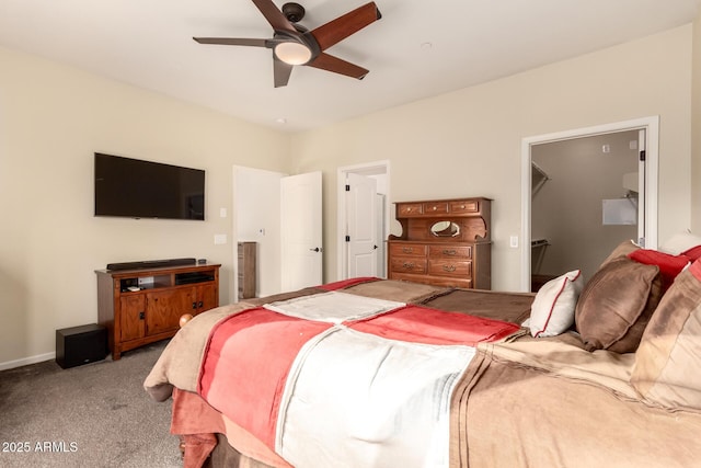 carpeted bedroom with a spacious closet, a closet, and ceiling fan