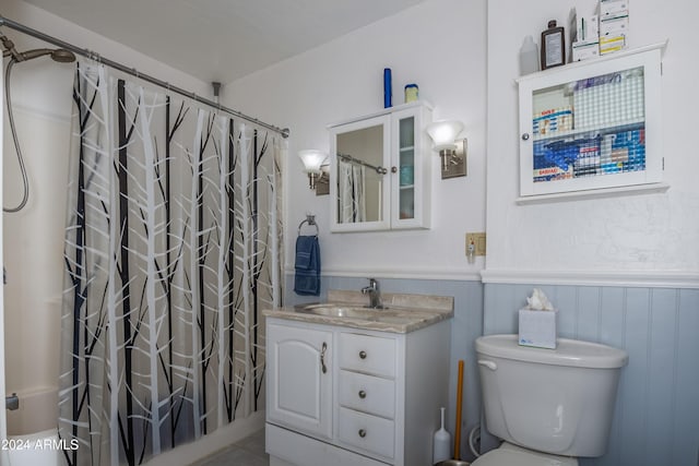 full bathroom with vanity, shower / bath combination with curtain, and toilet