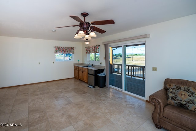 kitchen featuring ceiling fan and sink