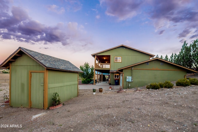 view of front facade featuring a storage shed
