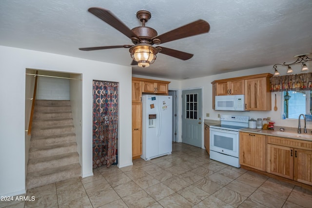 kitchen with a textured ceiling, white appliances, ceiling fan, and sink