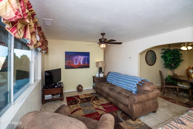 tiled living room with ceiling fan