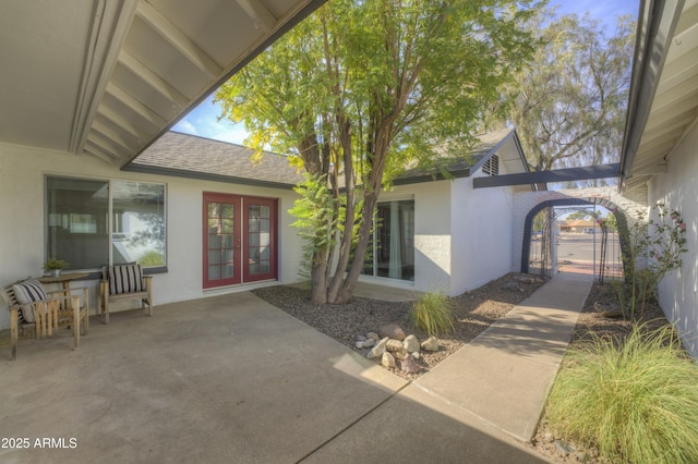 property entrance with a patio area and french doors