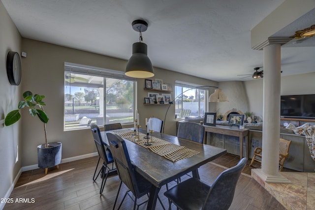 dining area with ceiling fan and ornate columns