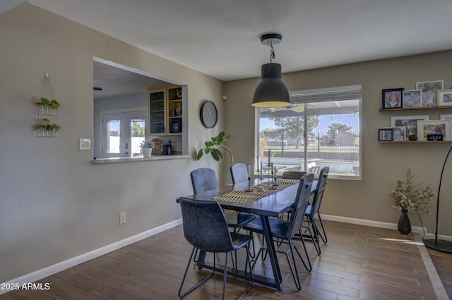 dining space with dark hardwood / wood-style floors