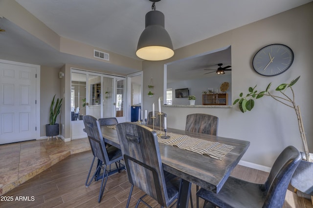 dining area with french doors and ceiling fan