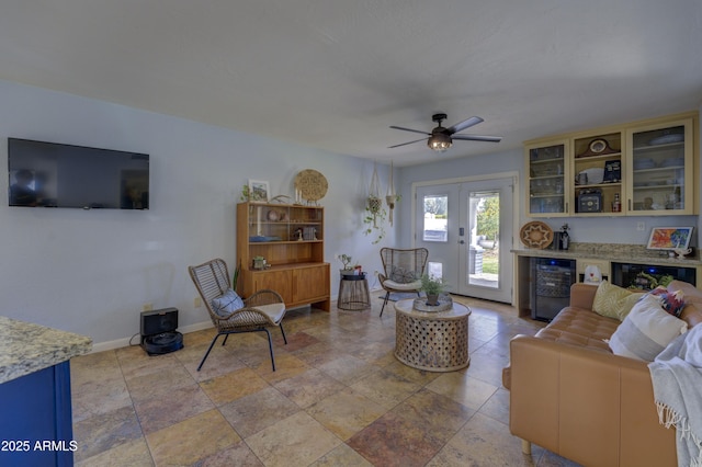 living room with bar area, ceiling fan, wine cooler, and french doors