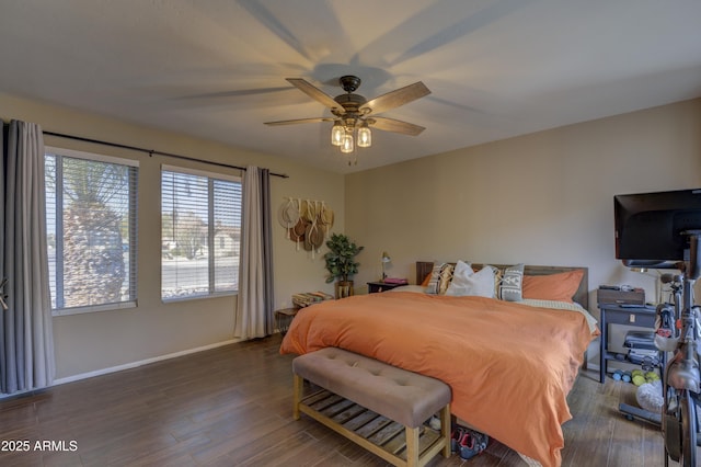 bedroom with ceiling fan and dark hardwood / wood-style floors