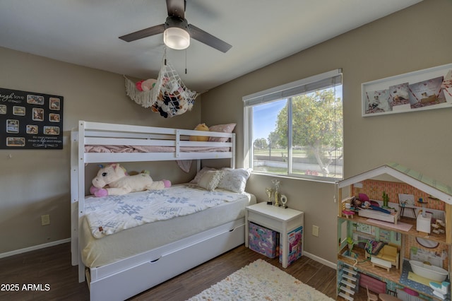 bedroom with ceiling fan and dark wood-type flooring