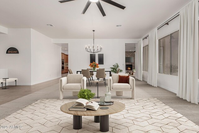 13204 W Palo Verde Dr, Litchfield Park, AZ 85340 - living area featuring ceiling fan, a chandelier, light carpet, baseboards, and a large fireplace