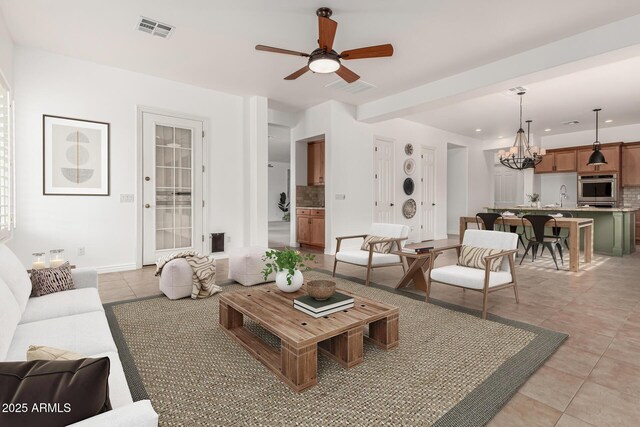 13204 W Palo Verde Dr, Litchfield Park, AZ 85340 - living room with a chandelier, light tile patterned floors, a ceiling fan, recessed lighting, and baseboards