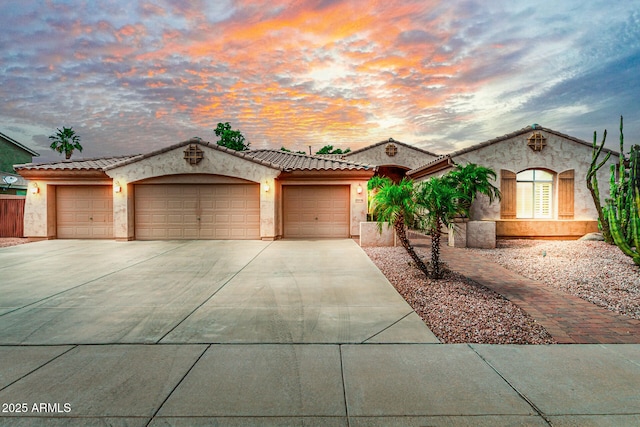 13204 W Palo Verde Dr, Litchfield Park, AZ 85340 - mediterranean / spanish house with concrete driveway, stucco siding, a garage, and a tile roof
