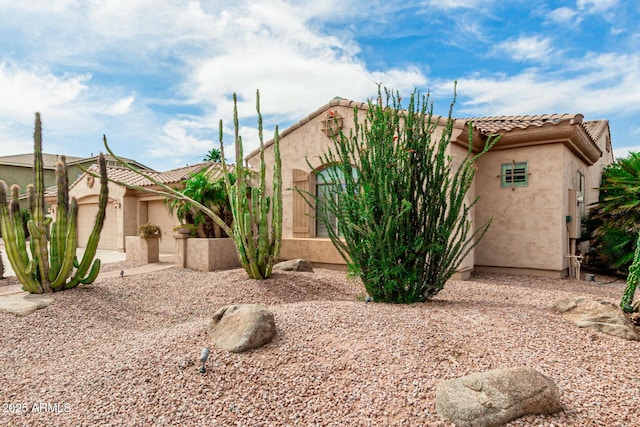 13204 W Palo Verde Dr, Litchfield Park, AZ 85340 - view of front facade featuring stucco siding, a tiled roof, and a garage
