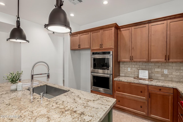 13204 W Palo Verde Dr, Litchfield Park, AZ 85340 - kitchen with double oven, a sink, brown cabinetry, backsplash, and recessed lighting