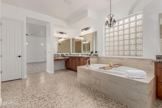 13204 W Palo Verde Dr, Litchfield Park, AZ 85340 - full bath with vanity, a bath, a chandelier, and healthy amount of natural light