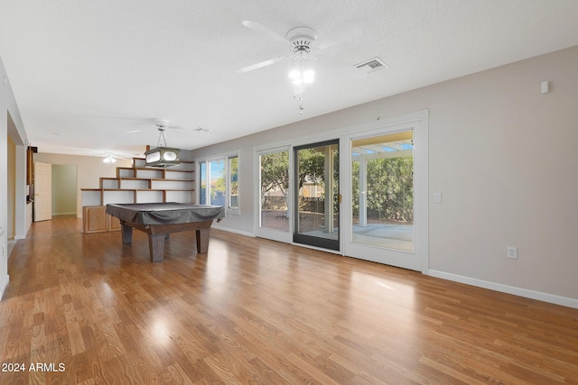 rec room with ceiling fan, plenty of natural light, billiards, and light wood-type flooring